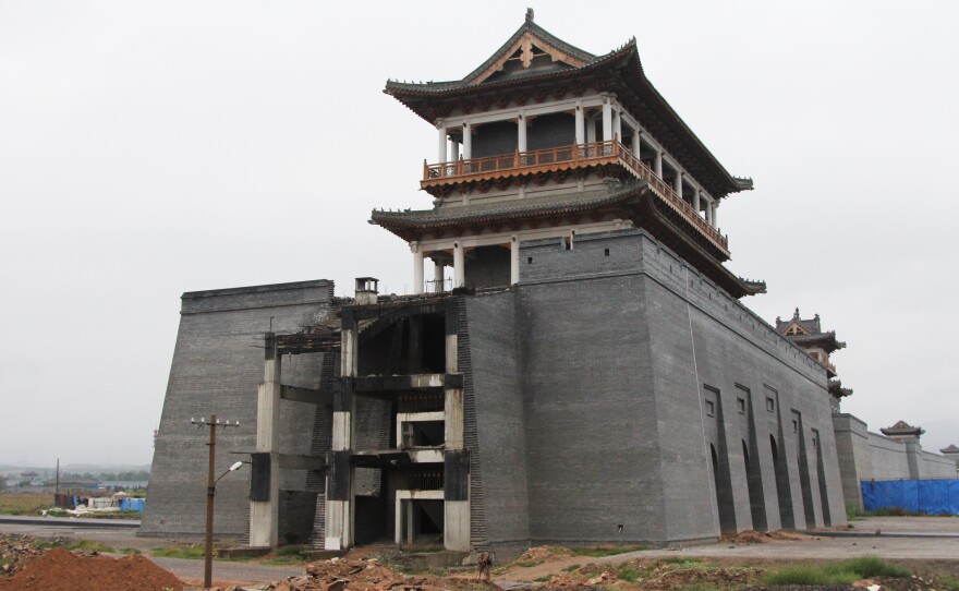 Luliang's planned "Liquor City" has run short of funding. Workers have yet to finish this replica of the Great Wall, which is supposed to surround a massive factory complex producing baijiu, an often expensive Chinese hard liquor.