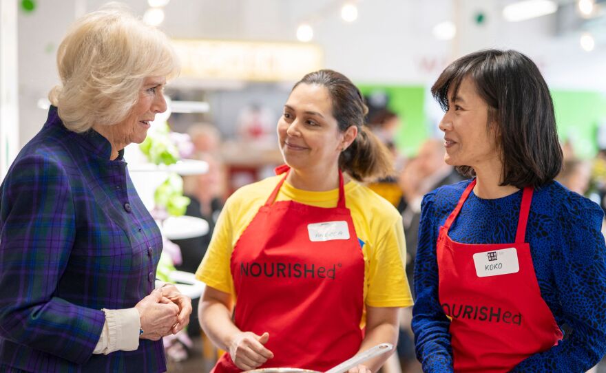 Britain's Camilla, Duchess of Cornwall speaks to members of staff as she attends the opening of the charity and community Kitchen "Nourish Hub," created to fight against social isolation and loneliness, in west London on Thursday.
