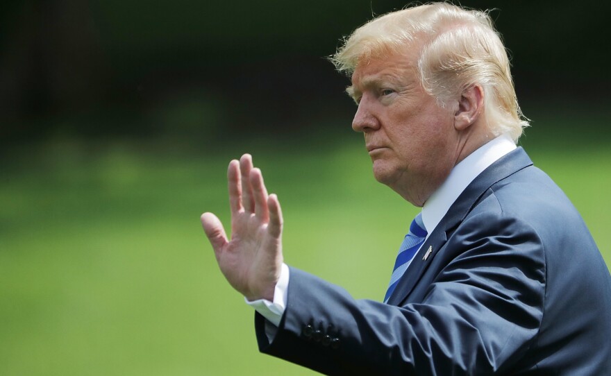 President Trump waves to visitors as he walks across the South Lawn before boarding Marine One and departing the White House on Friday.