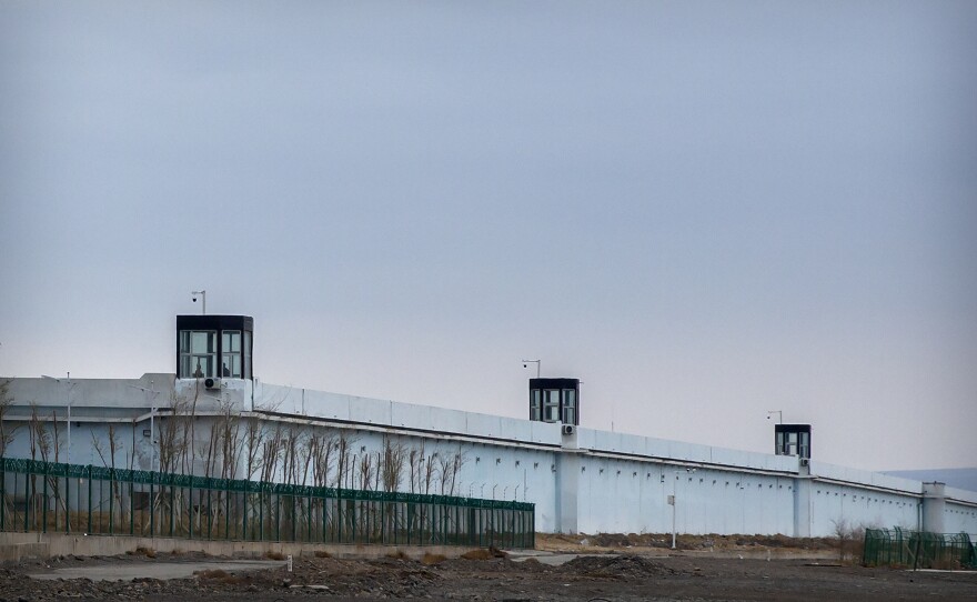 People stand in a guard tower on the perimeter wall of the Urumqi No. 3 Detention Center in Dabancheng, in western China's Xinjiang autonomous region, on April 23, 2021. China's largest detention center has room for at least 10,000 inmates.