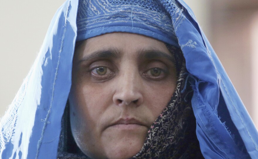 National Geographic's famed green-eyed "Afghan Girl" Sharbat Gula poses for a photo in 2016. The office of Premier Mario Draghi said the Italian government will now help to welcome her and get her integrated into her new life in Italy.