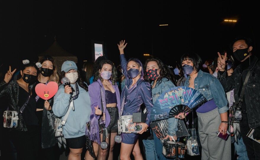 Fans wait in line for the BTS concert at SoFi Stadium in Inglewood.