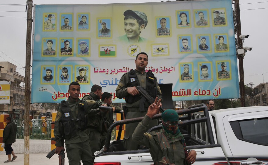 U.S.-backed Kurdish militants seem to be in talks with the Syrian regime to hand over the city of Manbij. Turkey has threatened an offensive against the town if the Kurds remain in control. Here, members of the Kurdish internal security force are seen in a photo from March.