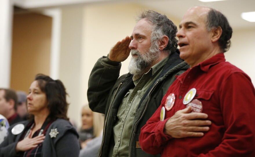 Audience members recite the Pledge of Allegiance at the start of a town hall-style campaign event held by Ted Cruz in Barrington, N.H., on Monday.