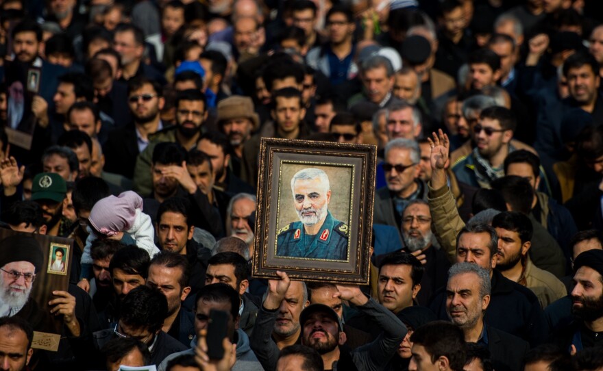 The U.S. killed Iranian Maj. Gen. Qassem Soleimani in a targeted drone strike in Baghdad. A U.N. investigator says the action violated Iraq's sovereignty. Here, protesters in Tehran, Iran, hold up an image of Soleimani during a demonstration on Jan. 3.