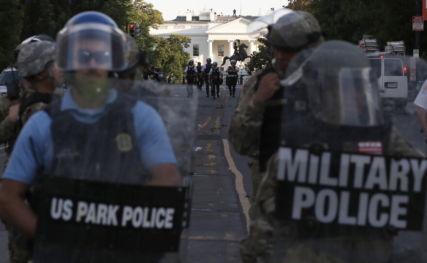 Authorities clear Lafayette Park in Washington, D.C., on Monday, while across the street at the White House, President Trump said he would send the military to U.S. cities if local officials don't end unrest.