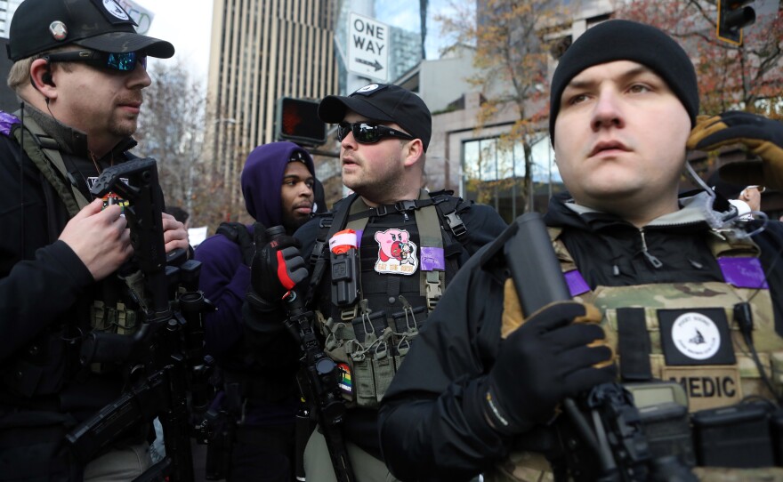 Armed leftist activists of the Puget Sound John Brown Gun Club protest during a rally by the Washington Three Percent in Seattle last month.