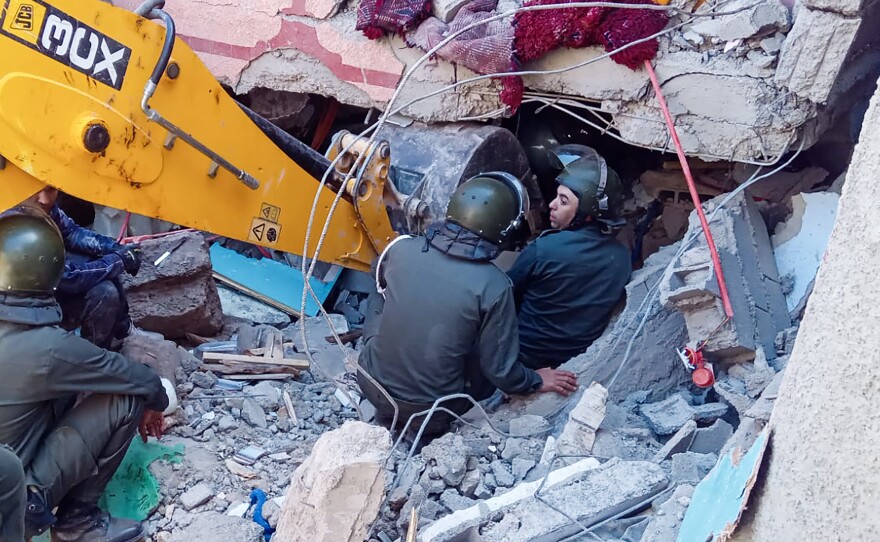 Rescue workers search for survivors in a collapsed house in Moulay Brahim, in Morocco's Al Haouz province, on Saturday after an earthquake.