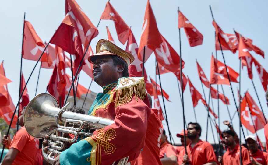 Workers and members of various trade unions dressed in red take part in a rally on the occasion of International Workers' Day in Bangalore, India.