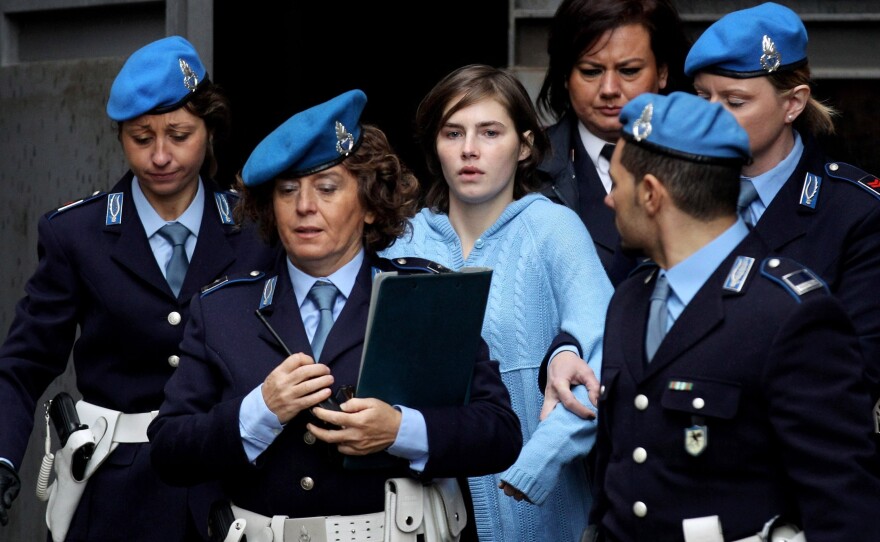 Police officers lead Amanda Knox from the Court of Appeal in Perugia, Italy, in November 2010.