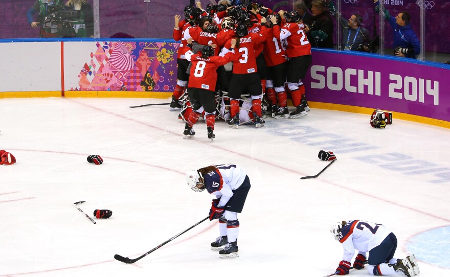 Marie-Philip Poulin (29) celebrates her winning overtime goal for Canada as American players try to recover from a game that seemed to be within their grasp in Sochi Thursday.