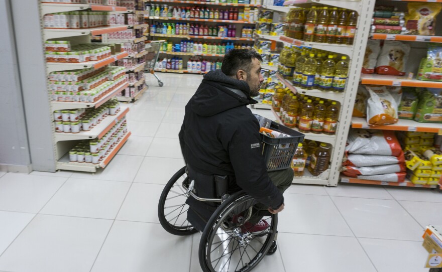 Triantafyllou shops at a local market. He was in a car accident in 2004 that left him paralyzed from the thorax down. When a product is on the top shelf, he usually asks for help.