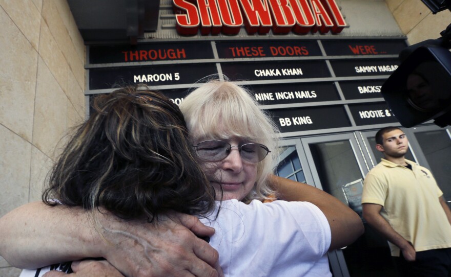 Longtime employees hug as they leave the Showboat Casino Hotel on Aug. 31, the day it closed.