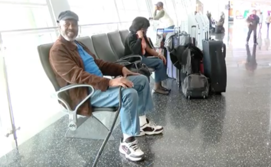 Tourist Milton Howard sits in San Diego's airport after learning his flight was canceled due to a blizzard, Jan. 22, 2016.