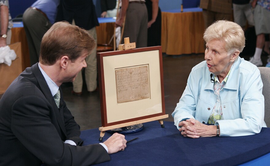 Francis Wahlgren (left) appraises an 1805 Davy Crockett marriage license in Tampa, Fla.