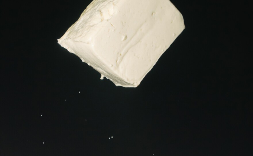 A block of tofu soars through the air.