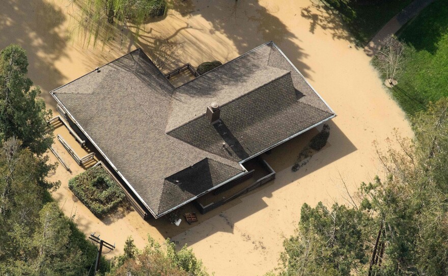 Floodwaters surround a home in San Jose, Calif., on Wednesday. Thousands of people were ordered to evacuate their homes as floodwaters inundated neighborhoods and forced the shutdown of a major highway.