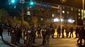 Pennsylvania State Police in riot gear line East College Avenue in the early morning hours on November 10, 2011 in State College, Pennsylvania.