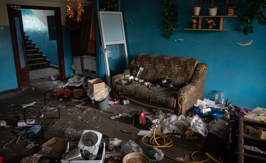 <strong>April 20:</strong> A sofa and other items that were dragged out of apartment units by Russian soldiers are seen strewn about an apartment complex's hallway in Hostomel, Ukraine.