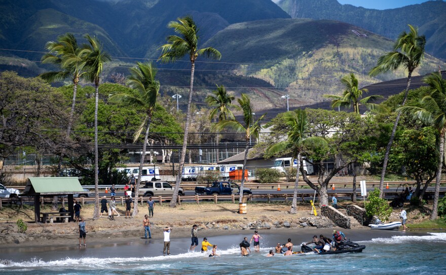 The local surfing community are shuttling donated items on jet boats to get them from from large boats to the shore on the north side of Lahaina.