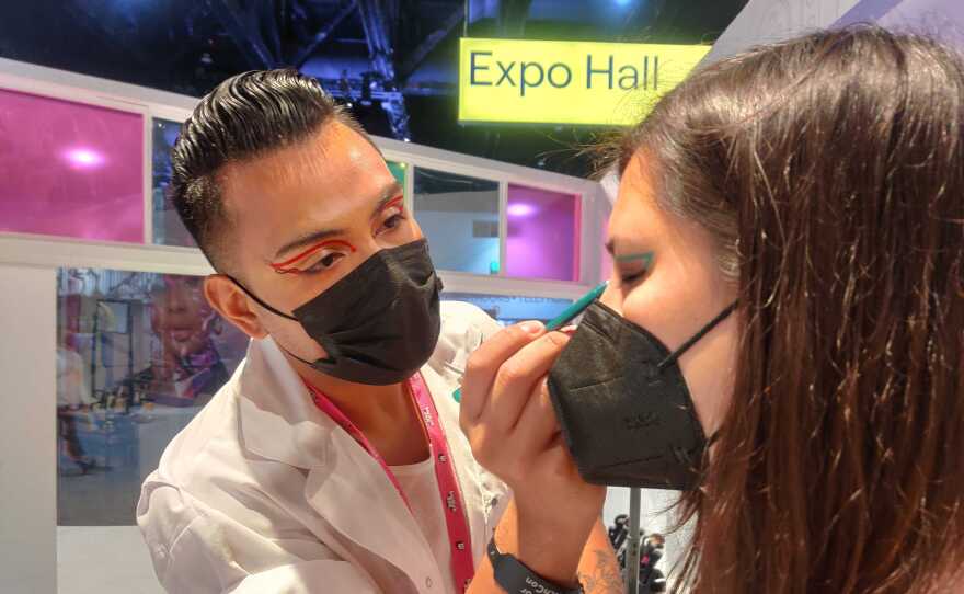 Martin Corona, pro makeup artist (and Final Fantasy gamer) at the NYX booth, applies makeup on Nicole Clarke, TwitchCon attendee, Oct. 9, 2022.