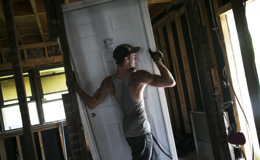 Blake Drummond works on a house in Springfield. Drummond was a high school dropout who went through a program at Opportunities for Individual Change. After getting his GED and taking construction and building classes, he now earns $21 an hour.