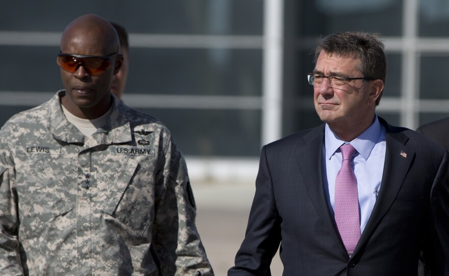 U.S. Army Lt. Gen. Ron Lewis (left) walks next to U.S. Defense Secretary Ash Carter before boarding a plane at Queen Alia Airport in Amman, Jordan, in July.