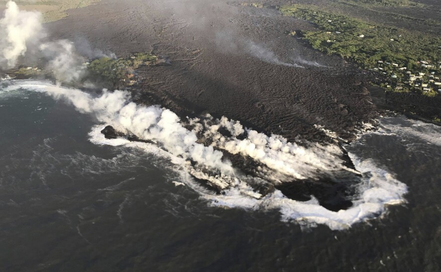 Lava enters the ocean at Kapoho Bay, Hawaii, on Tuesday. A U.S. Geological Survey morning overflight confirmed that lava had completely filled the bay.