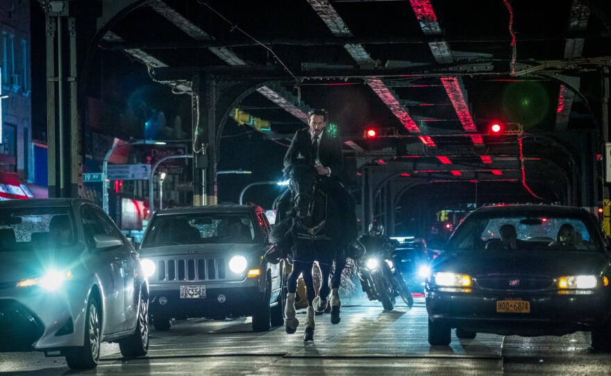 John Wick (Keanu Reeves) fights on horseback in "Chapter 3."