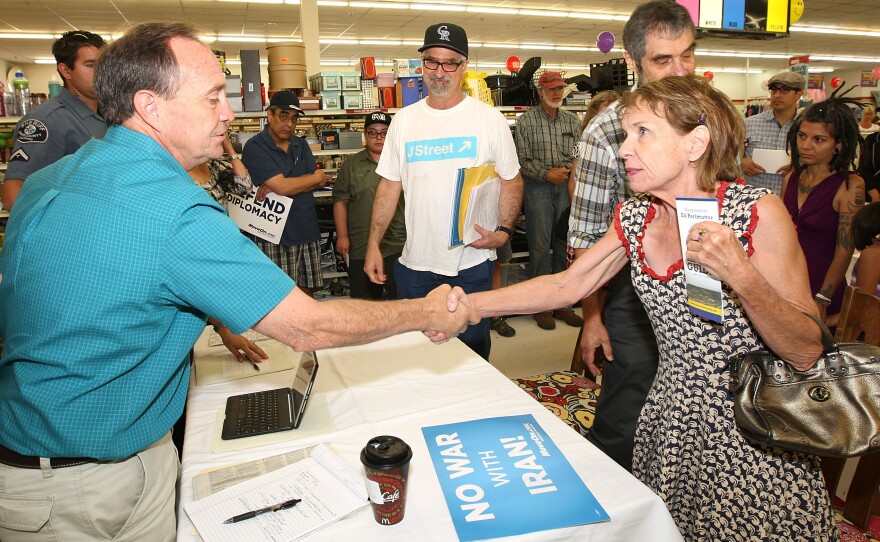 Rep. Ed Perlmutter shakes hands with Carlyn Meyer and other members of the groups J-Street and MoveOn.org as they urge him to support the Iran nuclear deal at an event in Denver. J-Street plans to spend about $5 million on ads in this fight, which is vastly dwarfed by the $20 million to $40 million from groups like AIPAC that oppose the agreement.