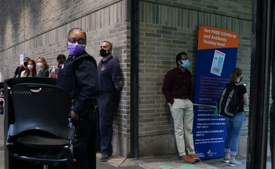 People stand in line for free COVID-19 testing at Bellevue Hospital in New York earlier this month. The daily number of new coronavirus cases reported in the U.S. has remained stubbornly high.