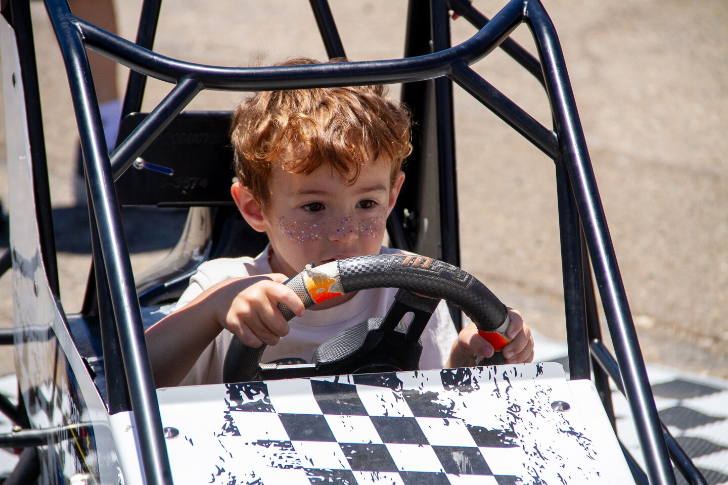 Child takes a ride in a kids display at NASCAR San Diego Weekend presented by Anduril at Naval Base Coronado on June 19, 2026.