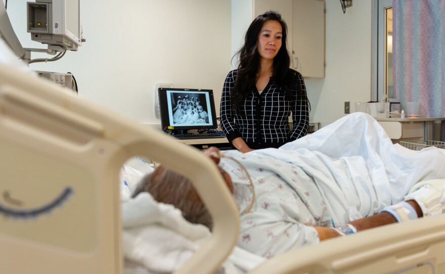 Lenh Vuong, a clinical social worker at Los Angeles County+USC Medical Center, checks on a former John Doe patient she recently helped identify.