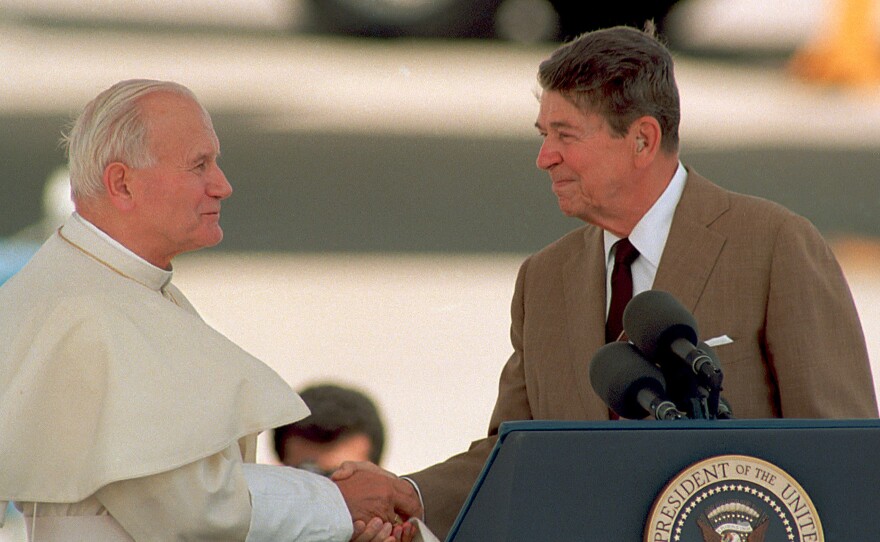 President Ronald Reagan shakes hands with Pope John Paul II at Miami International Airport, Fla., on Sept. 10, 1987.