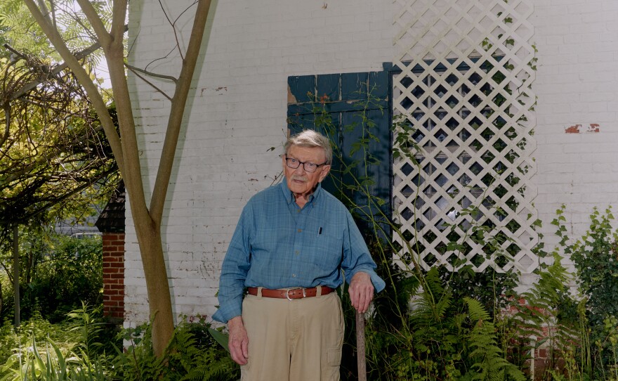 Brown poses for a portrait outside his home.