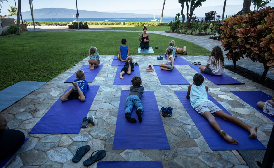 Kilihune Ka'aihue teaches a yoga class to children from Lahaina, many who lost their homes.