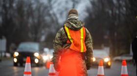 A New Jersey National Guard Airman provides traffic control at a COVID-19 Community-Based Testing Site at the PNC Bank Arts Center in Holmdel, N.J., March 23, 2020.