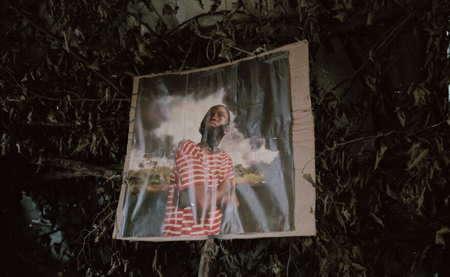 In their forest community, the activists display an altered image from Nigerian photojournalist George Osodi and his work highlighting multinational oil companies and their role in degrading the ecosystem.