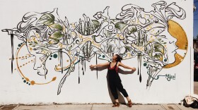 San Diego visual artist Mary Jhun is pictured with her mural in City Heights in 2019.