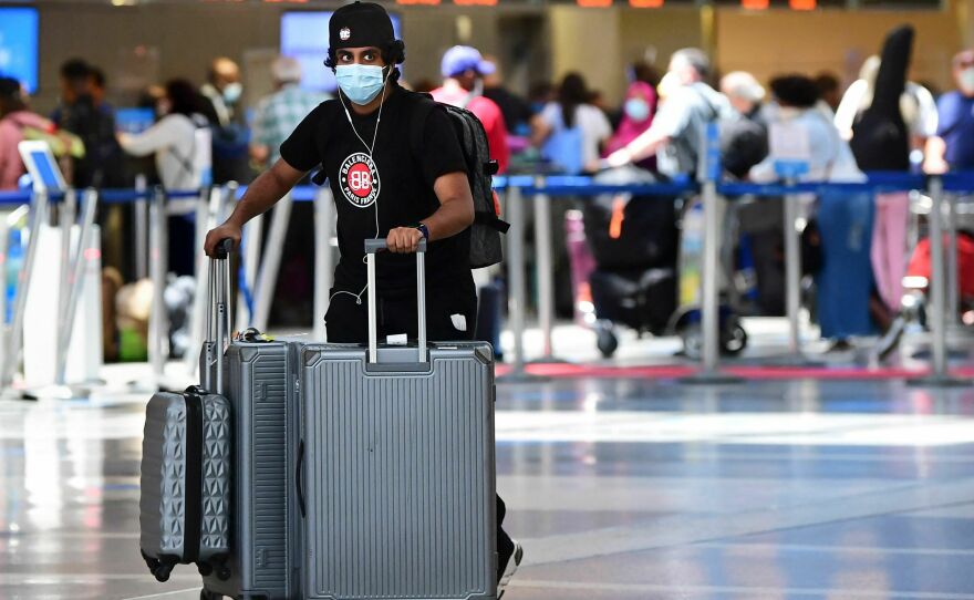 A man pushes his bags at Los Angeles International Airport (LAX) on May 27, 2021 in Los Angeles as people travel for Memorial Day weekend. The Department of Transportation has a website to assist travelers with knowing their rights.