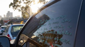 A note written in a parked car window in San Diego pleads with police to not tow the car, June 27, 2023.