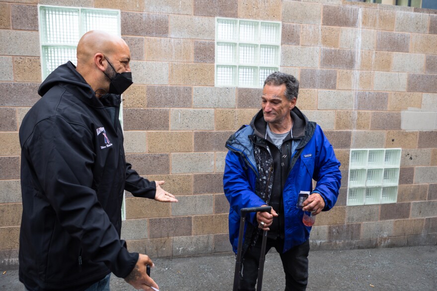 Kenneth Garcia arrives at a shelter with Alpha Project outreach worker Craig Thomas in San Diego, April 18, 2023. After sleeping outside for a week a bed opened for him.