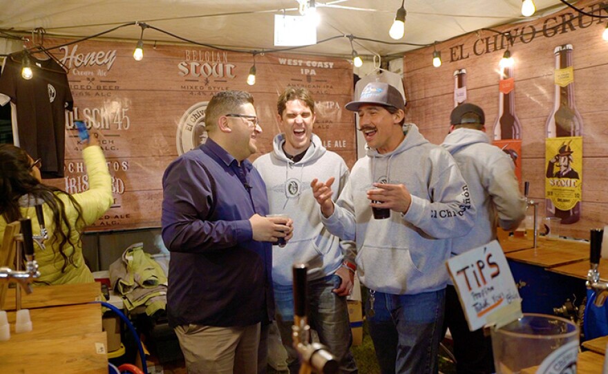 Host Jorge Meraz talks with some of the award-winning beer makers at the Ensenada Beer Festival.