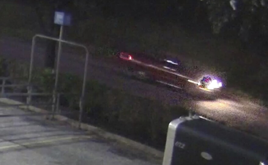 An image taken from surveillance video of a pickup whose driver, according to authorities, fired several shots into a car carrying a family near Houston, killing a 7-year-old girl.