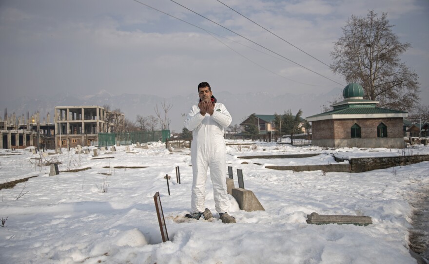 Jamil Ahmad Digoo, 47, an ambulance driver in Srinagar, Kashmir, prays in the Malkhah cemetery in Srinagar, where he has buried patients who died of COVID-19. Speaking of one of the women he buried, he says: "Even now, every night, in my prayers, I apologize to God and this lady in case I might not have accorded her the respect she otherwise deserved."