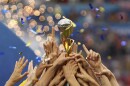 In this photo from July 7, 2019, U.S. players hold the trophy as they celebrate winning the Women's World Cup final soccer match against The Netherlands at the Stade de Lyon in Decines, outside Lyon, France. The 2023 Women's World Cup will be spread across nine cities in Australia and New Zealand.