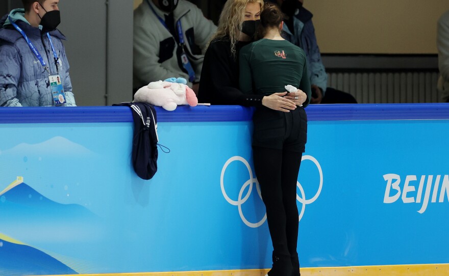 Kamila Valieva of Team ROC stands with coach Eteri Tutberidze during a figure skating training session at the Beijing Winter Olympics on Saturday, February 12, 2022.