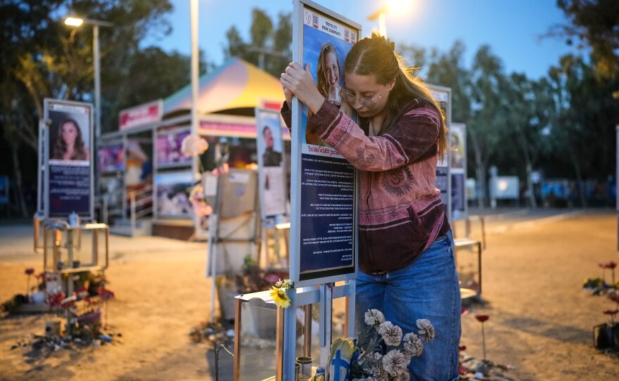 Raz Zarfati, sister of Ron Zarfati who was killed in the Oct. 7, 2023, Hamas attack on Israel, attend a memorial marking the third anniversary of the attack at the Nova music festival site near Kibbutz Reim, southern Israel, Wednesday, Oct. 7, 2026.
