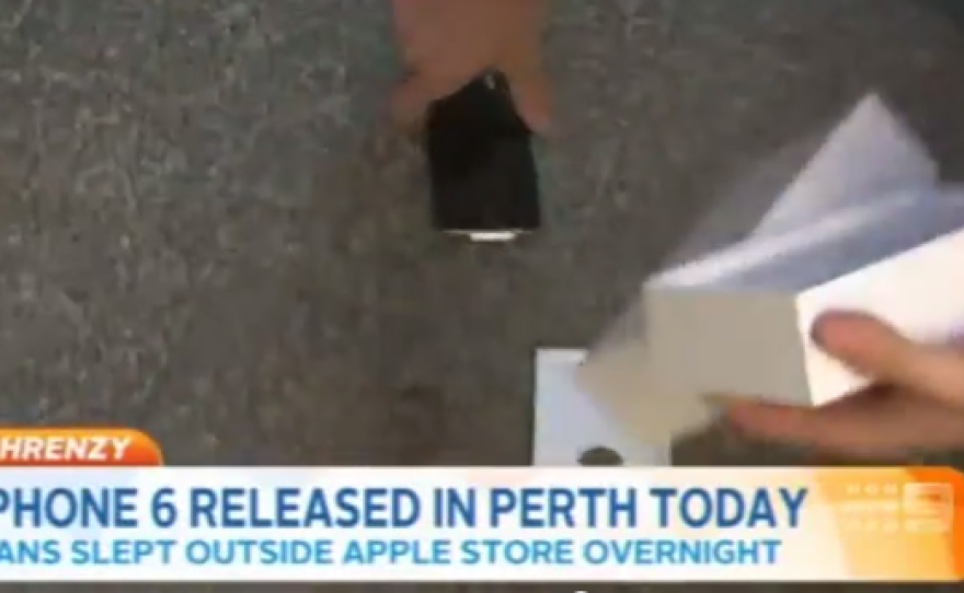 A customer picks up his just-bought iPhone.