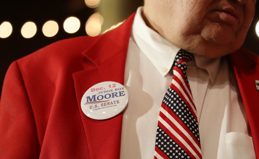 A supporter of Republican senatorial candidate Roy Moore attends a campaign rally at Oak Hollow Farm in Fairhope, Ala., on Dec. 5. Moore faces Democrat Doug Jones on Tuesday.